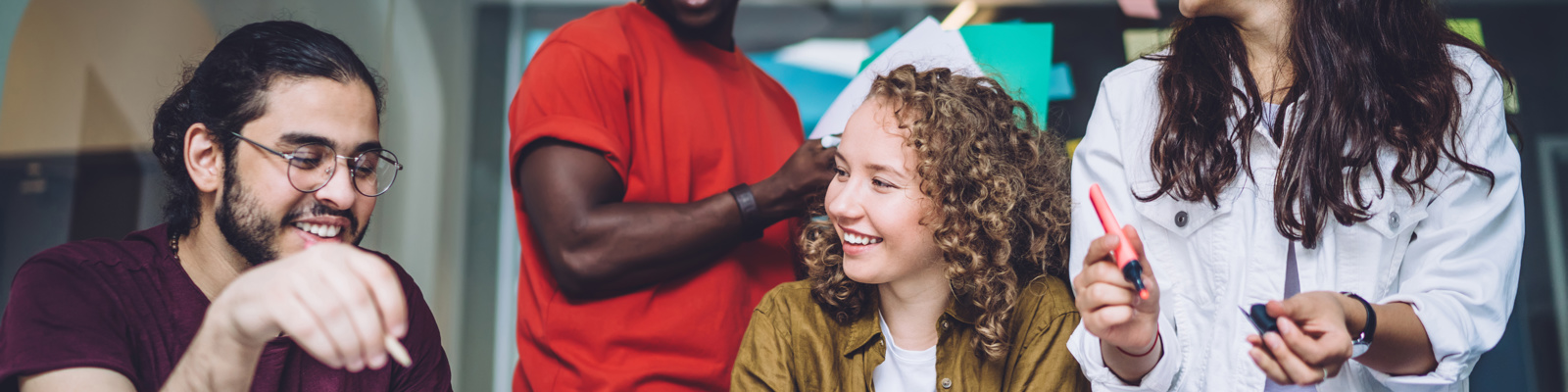 Cheerful group of 4 people working together.