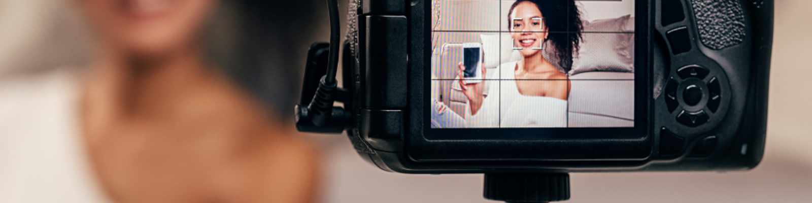 A young black woman is shown on a camera, recording herself