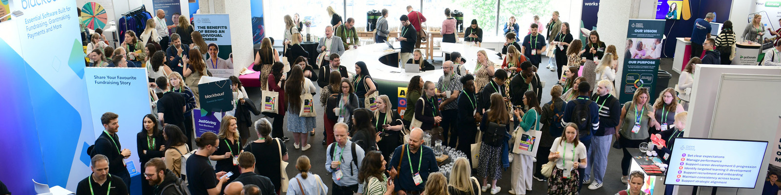 Photo of Fundraising Convention 2025, Delegates move between various stands. 