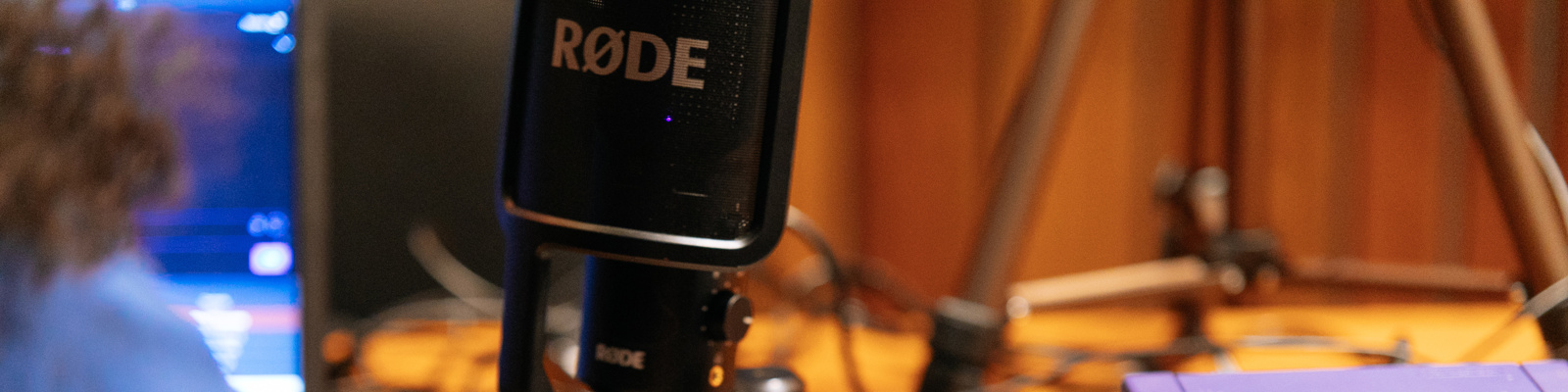 Photo of Recording Equipment with a Person Working on a Laptop next to it.